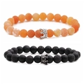 Detail view of 8mm orange crackle stone and matte black beaded bracelets with crown charms - Pattern B White Gold Crown Set