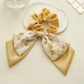Detail of yellow silk floral double-layered bow scrunchie on a decorative cloud tray - Double Layer Bow / Light Yellow