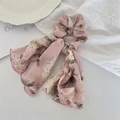 Detail of pink floral fabric scrunchie with long ribbons on white aesthetic background - Pink Floral With Trim