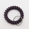 Macro shot of dark purple spiral wristband keychain with a polished silver metal ring - Dark Purple