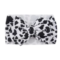 Infant headband featuring a large bow with black and white cow print patterns - #3 Cow Print