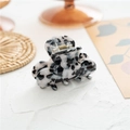 Elegant black and white marble acetate hair claw clip on a minimal woven background - Black & White