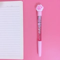 Cute pink cat paw gel pen with floating liquid glitter on a pink notebook background - Cat Claw
