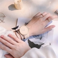 Detail of macaron minimalist watch with whale tail bracelet and gold rings on a model - No Box / Milk Yellow