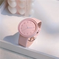 Close-up of pink minimalist watch with embossed 3D numerals and leather strap detail - No Box / Pink
