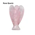 Macro shot of hand-carved natural rose quartz angel sculpture with detailed wings - Rose Quartz