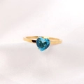 Macro shot of gold stainless steel ring featuring a heart-shaped blue gemstone on silk - US 8 / Royal Blue + Gold
