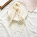 Detail of cream white fabric scrunchie with long ribbons on a decorative ceramic plate - Style with Streamer / Beige
