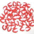 Close-up of red strawberry polymer clay beads for DIY jewelry and handmade crafts - Strawberry