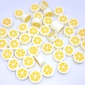 Detailed view of 10mm white polymer clay beads with yellow lemon pattern and center holes - Banana