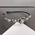 Macro detail of handmade dark cyan crystal headband with sparkling beads on a thin frame - Malachite green