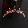Detail of a golden alloy crown featuring red teardrop crystals and vintage openwork design - Teardrop Red Gemstone / Gold Red