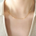 Minimalist gold-plated titanium steel necklace with rectangular bar link details worn by model - Gold