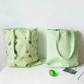 Dual-style light green canvas tote bags featuring avocado print and minimalist solid design - Green Avocado