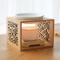 Bamboo and ceramic aroma oil burner with cutout design and lit candle on wood table - Bamboo Hollow