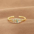 Adjustable gold evil eye ring with blue stones on a luxury brown silk background - Evil Eye Wavy Band (Q-J075) / Gold