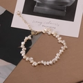 Elegant baroque pearl bracelet with golden heart pendant and lobster clasp on brown desk - 973# Titanium Steel Natural Pearl Bracelet