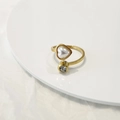 Golden adjustable heart pearl ring with round zircon inlay on a minimalist white stand - Heart Pearl/Zirconia / Adjustable Open / Gold