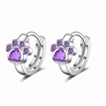 Close-up of silver cat paw earrings with purple heart zircon and claw settings - Purple Zirconia