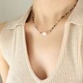 Colorful gemstone beaded necklace with a central white freshwater pearl on a model - Gold