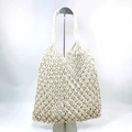 Close-up of white macrame tote bag featuring intricate hollow diamond mesh weave - White