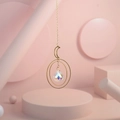 Detail of golden moon suncatcher with multifaceted crystal ball reflecting aurora light - No. 1
