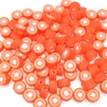 Macro detail of orange polymer clay fruit beads for DIY jewelry making and crafts - Tomato