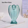 Detailed close-up of a translucent sea blue glass angel figurine with polished edges - Synthetic Sea Blue Glass