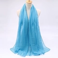 Detail of light blue sheer voile scarf draped on a model showing lightweight fabric texture - Lake Blue