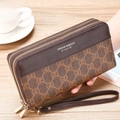 Close-up of brown long wallet with vintage texture, dual metal zippers and wrist strap - Brown Floral Monogram Texture