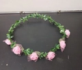 Pink foam rose floral headband with 6 roses and green leaves on a dark surface - Pink