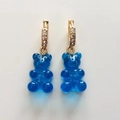 Detail of blue resin gummy bear earrings with gold rhinestone encrusted hoops - Transparent Blue