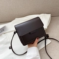 Deep brown vintage square crossbody bag with flap cover on white shirt backdrop - Brown