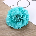 Detailed close-up of a lake blue silk peony flower clip on a minimalist wooden background - Aqua Blue