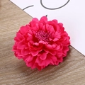 Macro shot of rose red fabric carnation flower head with detailed petals and wood background - Rose Red