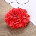 Macro detail of red fabric peony hair clip featuring layered petals and realistic stamens - Watermelon red
