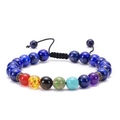 Lapis blue braided lava stone bracelet with seven chakra beads on a white background - Lapis Lazuli Bracelet