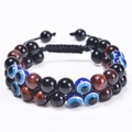 Detailed shot of double-layer woven bracelet with 8mm tiger eye beads and evil eye charm - Red Tiger Eye + Black Beads + Evil Eye (3 Beads)