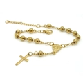Detail of gold beaded rosary bracelet featuring cross pendant and religious saint medal - Gold