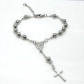 Macro detail of stainless steel rosary bracelet featuring cross and Virgin Mary medal - Steel