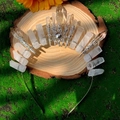 Detail of natural clear quartz crystal crown with sunburst motif on mossy wood base - White + Sun