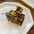 Detail of tortoise shell hair claw clip with glossy finish on a white jewelry tray - Small / Leopard Print