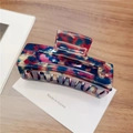 Detail of square resin hair claw with colorful tortoiseshell pattern on display card - Large / Purple Floral