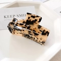 Detail of a rectangular tortoiseshell leopard print hair clip on a white jewelry tray - Large / Light Leopard