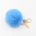Dettaglio di portachiavi con pompon blu, ciondolo a foglia dorata e gancio in metallo - Blu