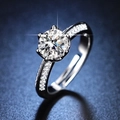 Macro shot of silver six-prong round cut simulated diamond ring with side accent stones - Y080【1 Carat】