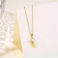 Detailed view of a gold-plated carrot pendant with zircon inlay on a white card display - Gold