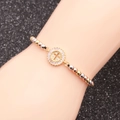 Three-tone beaded bracelet with sparkling pavé crystal cross charm on wrist - Cross