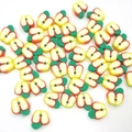 Detailed close-up of handmade 10mm apple-shaped polymer clay beads for DIY jewelry making - Yellow Apple