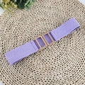 Close-up of purple elastic woven waist belt with a textured golden metal interlocking buckle - Purple